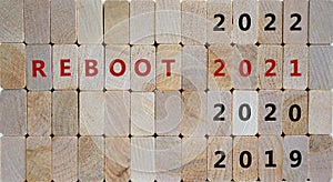 2021 reboot new year symbol. Wooden blocks with the inscription `reboot 2021`. 2019, 2020, 2022 numbers. Beautiful wooden