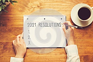 2021 Resolutions with a person holding a pen