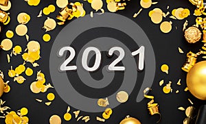 2021 white text lettering in golden confetti, Christmas festive decor frame on black background. Happy New year event composition