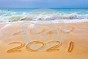 2021 written on the sand of a beach travel 2021 new year concept and greeting card