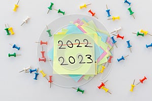 2022 and 2023 written on a yellow sticky note