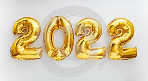 2022 balloon text on white background. Happy New year eve invitation with Christmas gold foil balloons 2022. Flat lay long web