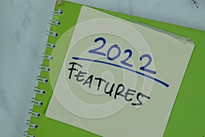 2022 Features write on sticky notes isolated on Wooden Table