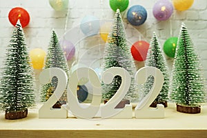 2022 Happy New Year festive background with christmas tree on white brick wall background