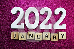 2022 January alphabet letters on pink glitter background