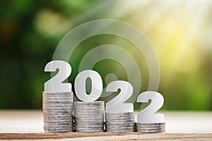 2022 New year on coins stack for saving money and financial planning concept