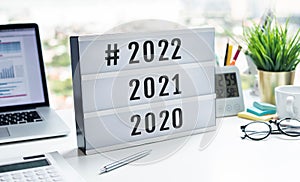 2022 new year countdown or business goals concepts with text number on light box on desk
