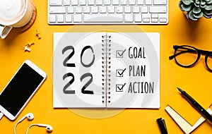 2022 new year goal,plan,action concepts with text on notepad and office accessories.Business management