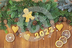 2022 numbers from the test. Christmas or New Year decoration background. Fir twigs, Christmas gingerbread cookies on a wooden