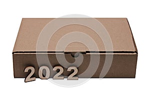 2022 numerals of the new year and the Cardboard brown closed rectangular box