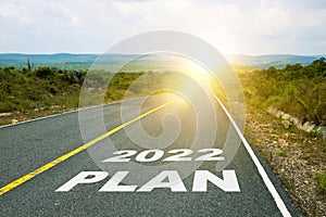 2022 Plan, concept photo of asphalt road. Motivational inscription on the road going forward. The beginning of a new path. A