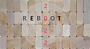 2022 reboot new year symbol. Wooden blocks with words `Reboot 2022`. Beautiful wooden background, copy space. Business, 2022