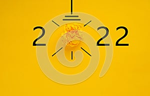 2022 Yellow paper light bulb on blue background, innovative business vision