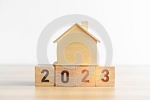 2023 block with house model. real estate, Home loan, tax, investment, financial, savings and New Year Resolution concepts