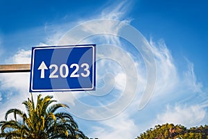 2023 blue road sign with cloudy blue sky. New year concept and background