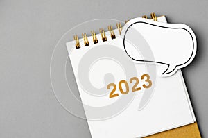 The 2023 desk calendar with speech bubble on grey colour background