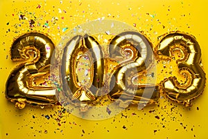 2023 Happy New Year concept from golden foil balloon