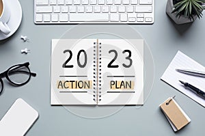 2023, new year action plan concepts with text on notepad and office accessories