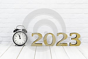 2023 new year and alarm clock on white wood table over white background with copy space , time concept