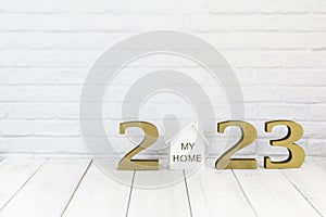 2023 new year and home on white wood table over white background with copy space , Real estate concept