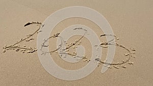 2023 numbers on sandy beach Happy New Year 2023, number hand written. Numbers 2023 written on the sand beach shore