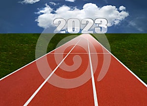 2023 with Running track with three lanes over sky and clouds concept of business ambition
