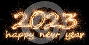 2023 sparkler golden number with happy new year eve greetings bright gold fireworks display black. dark celebration change of the