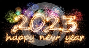 2023 sparkler number with colorful fireworks display on black background. happy new year eve dark celebration concept
