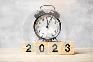 2023 text with clock on table. Resolution, time, plan, goal, motivation, reboot, countdown and New Year holiday concepts