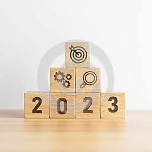 2023 wood block with business goal, plan. Action strategy, target, mission, teamwork, idea and New Year start concept
