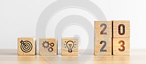 2023 wood block with business goal, plan. Action strategy, target, mission, teamwork, idea and New Year start concept