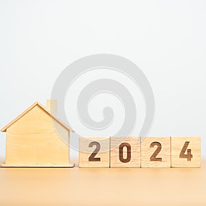 2024 block with house model. real estate, Home loan, tax, investment, financial, savings and New Year Resolution concepts