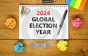 2024 global election year symbol. Concept words 2024 global election year on beautiful white note. Beautiful wooden table