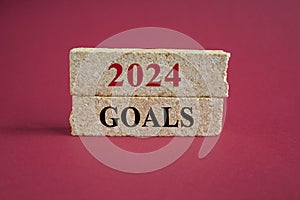 2024 goals word on brick blocks. Beautiful red background.