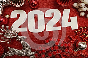 2024 Happy New Year and Christmas decoration on red glitter background