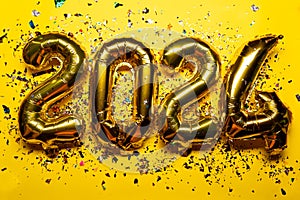 2024 Happy New Year Concept - golden foil balloon and confetti