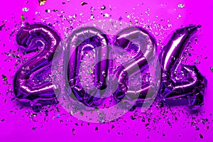 2024 Happy New Year Concept - pink foil balloon and confetti