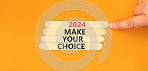 2024 Make your choice symbol. Concept words 2024 Make your choice on wooden stick. Beautiful orange table orange background. Voter