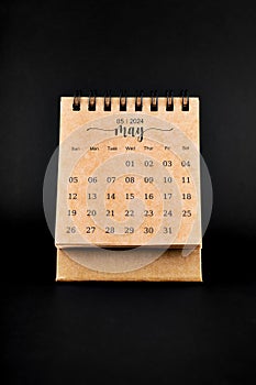 2024 May brown desk calendar on black