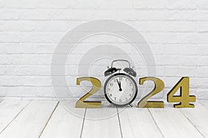2024 new year and alarm clock on white wood table over white background with copy space , time concept
