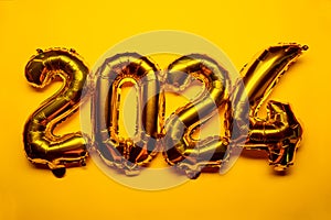 2024 New Year Concept - golden foil balloon and confetti