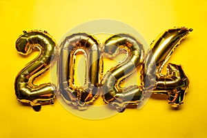 2024 New Year Concept - golden foil balloon and confetti