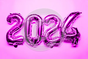 2024 New Year Concept - pink foil balloon and confetti