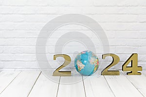 2024 new year and globe on white wood table over white background with copy space , save earth concept