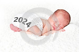 2024 Newborn baby posed on a white blanket.