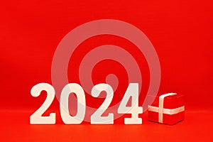 2024 number with Red Gift Box on red pattern background - End of year 2023 and Happy new year 2024 concept