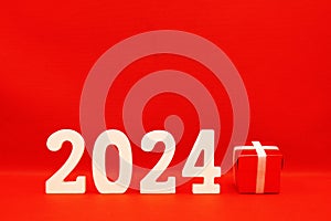 2024 number with Red Gift Box on red pattern background - End of year 2023 and Happy new year 2024 concept