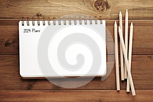 2024 plans on blank notebook paper on white background, 2024 new year mock up, template, flat lay