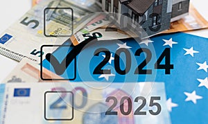 2024 TAX. Woman holding a card with a message text written on it.