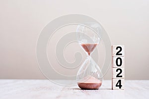 2024 text with hourglass on table. Resolution, time, plan, goal, motivation, reboot, countdown and New Year holiday concepts